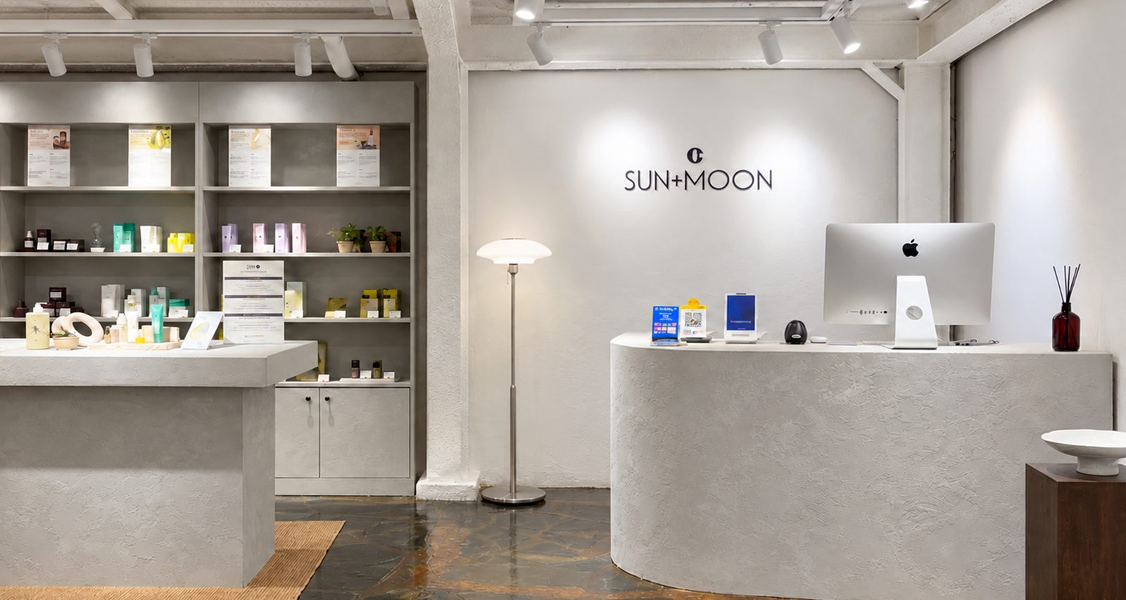 Inside SUN+MOON Seongsu — logo wall, counter and K-beauty shelves